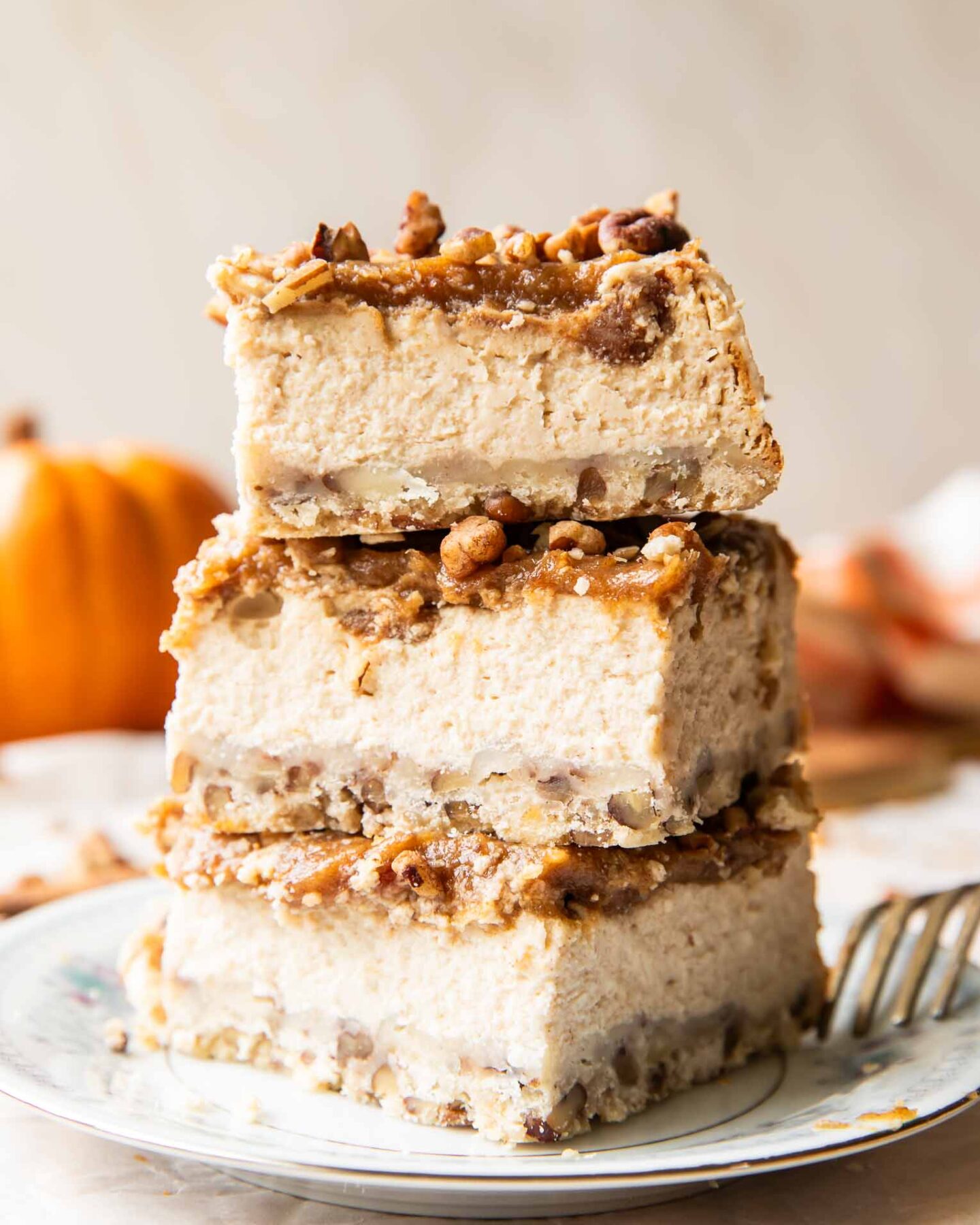 Date Caramel Cheesecake Bars stacked on top of each other.