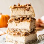 Date Caramel Cheesecake Bars stacked on top of each other.