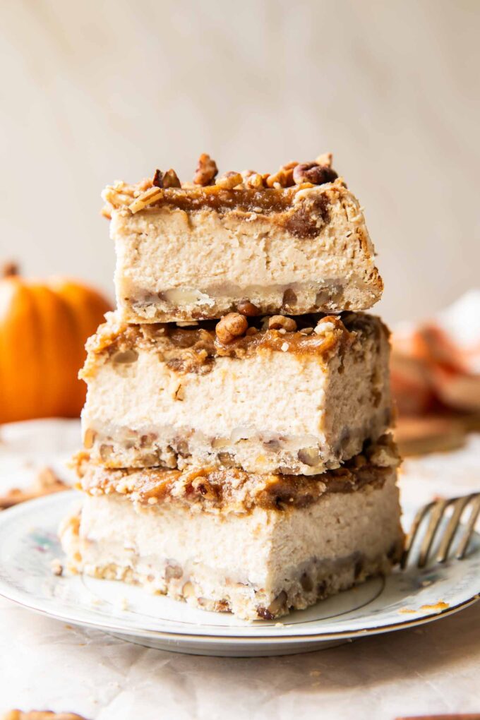 Date Caramel Cheesecake Bars stacked on top of each other.