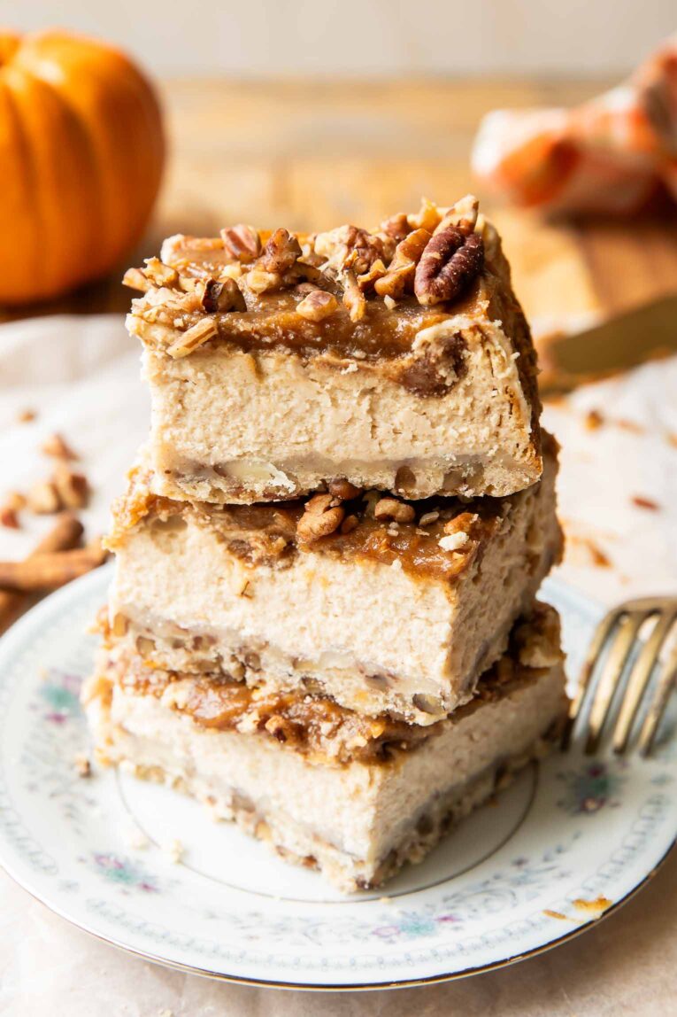 Date Caramel Cheesecake Bars stacked on top of each other.