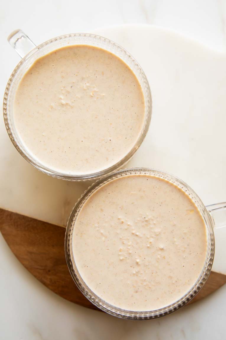 Biscoff overnight oats in two glass cups.
