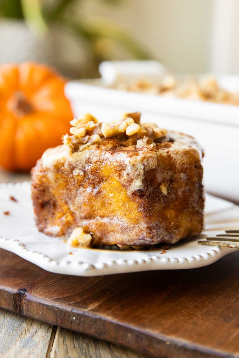 Pumpkin Cinnamon roll on a plate.