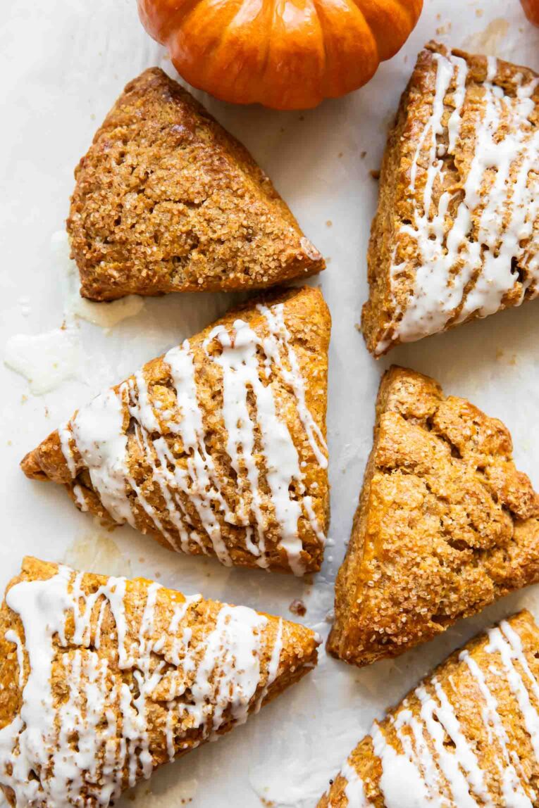 Pumpkin cottage cheese scones on a white surface.