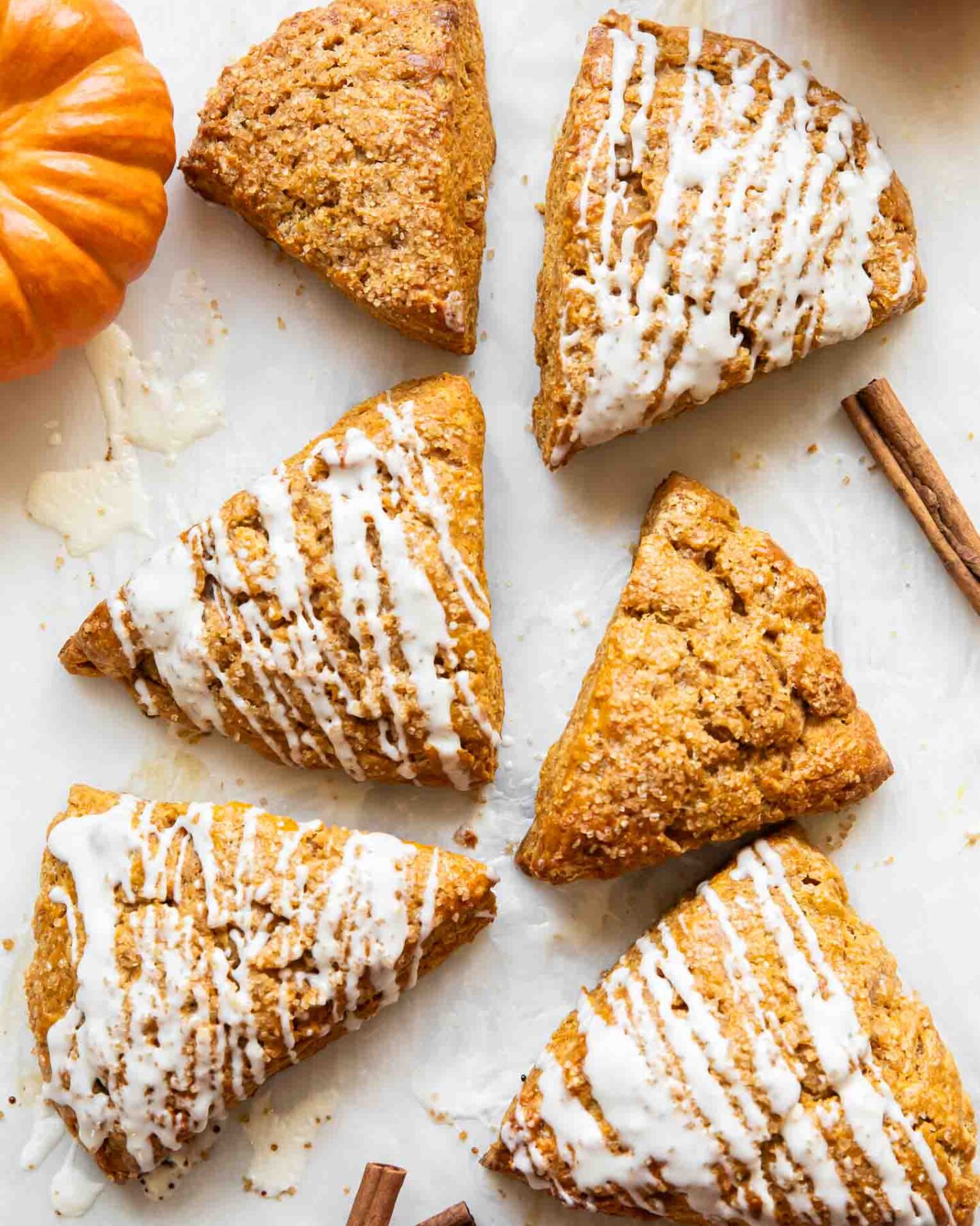 Pumpkin cottage cheese scones on a white surface.