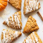 Pumpkin cottage cheese scones on a white surface.