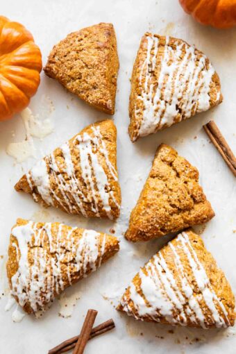 Pumpkin cottage cheese scones on a white surface.